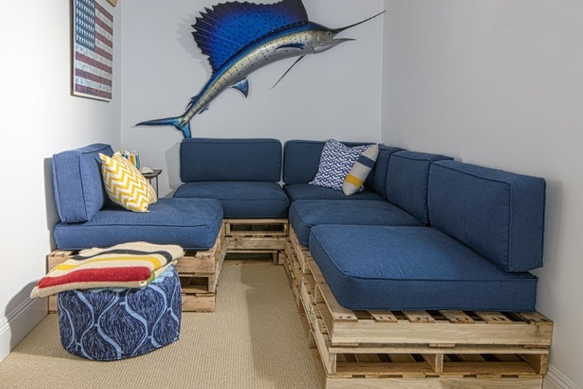 Wooden pallet couches with patriotic swordfish hanging overhead
