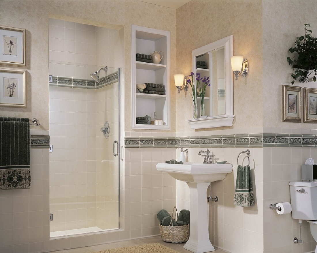 Small sink with two wall sconces above on either side of the mirror.