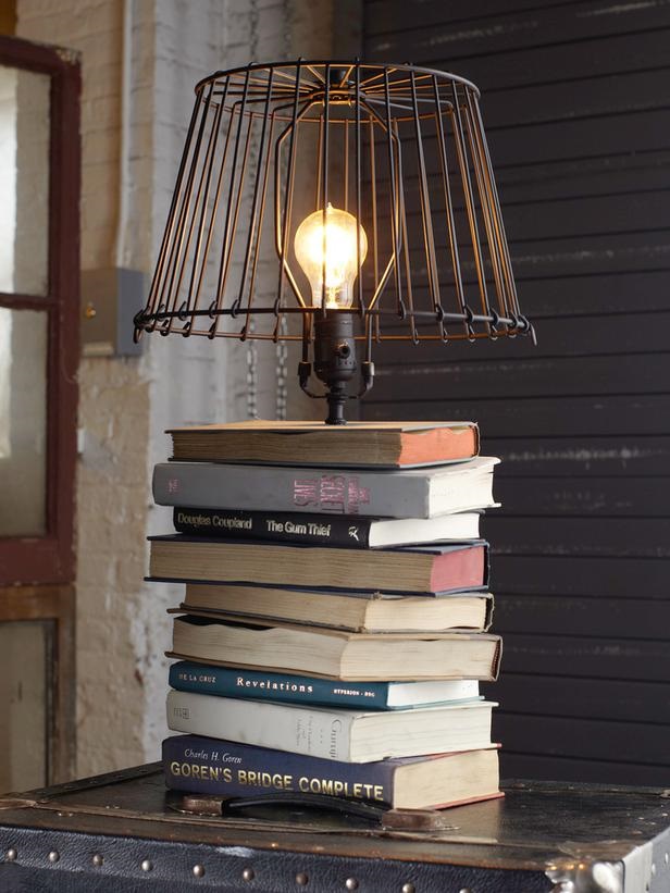 Homemade industrial light atop stack of used library books as the base of the lamp.