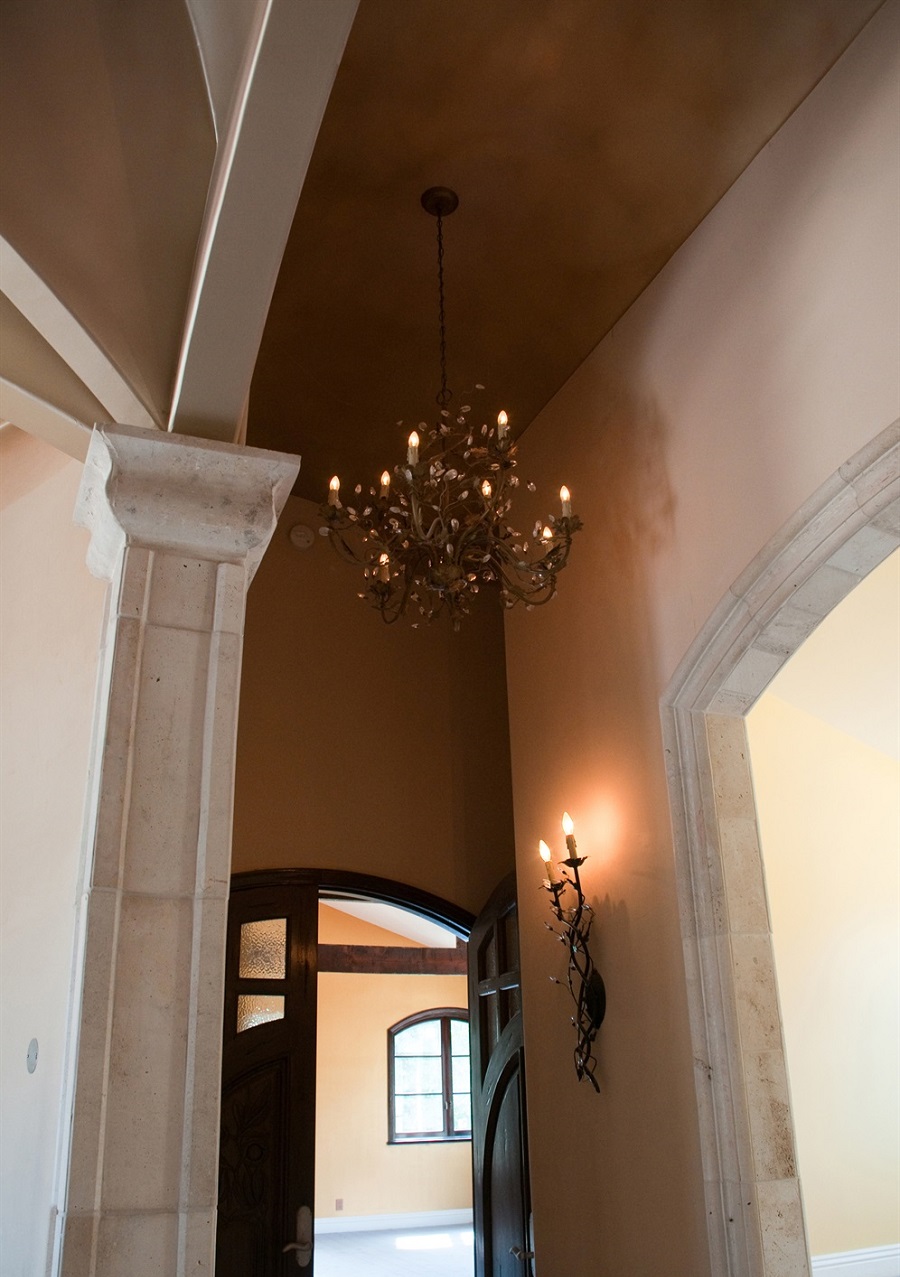 High arched ceiling with hanging chandelier and mounted candles