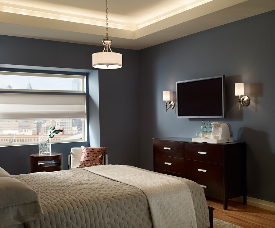 Bedroom with hanging lights and mounted wall fixtures